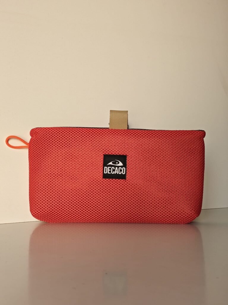 Neceser de viaje compacto de malla coral Decaco, ideal para organizar cosméticos o accesorios.
